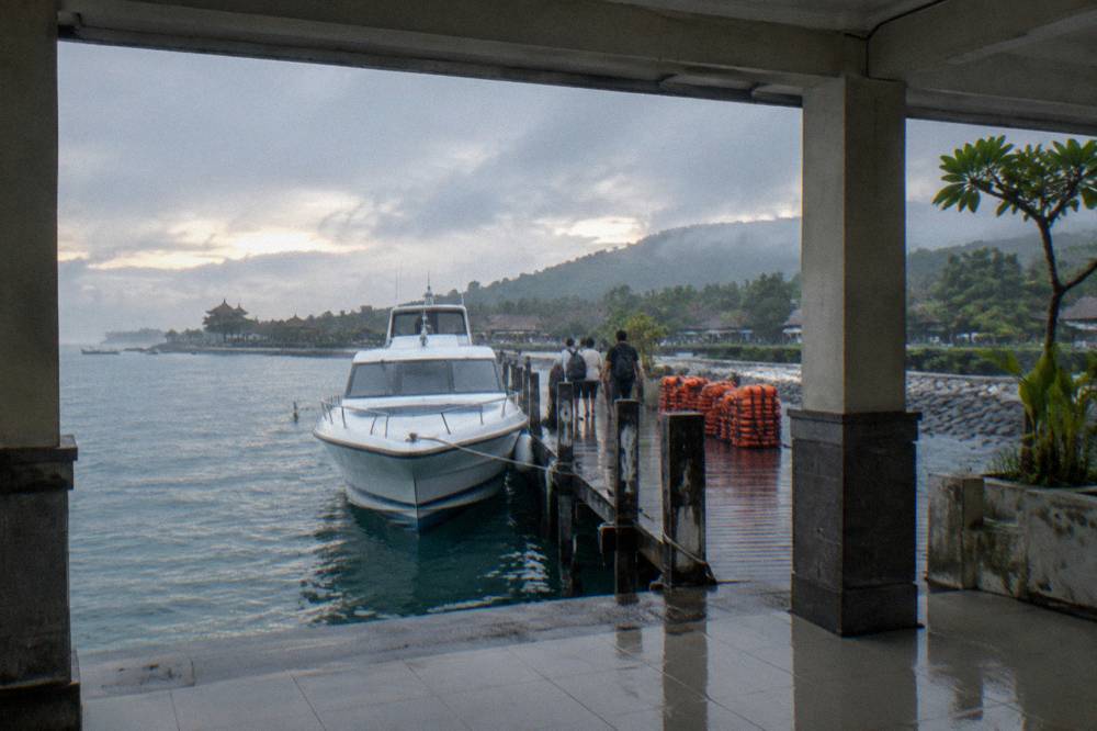 Fast boats moored at a harbour with passengers boarding in the morning