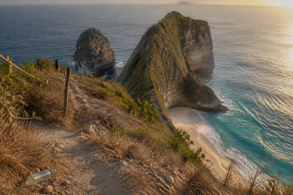 Golden afternoon light on the Kelingking cliff and the beach below on Nusa Penida