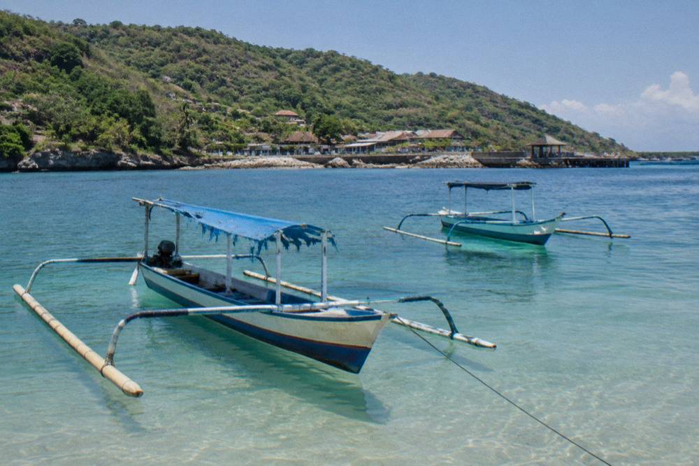 Calm turquoise water and clear sky over a small island anchorage in dry season