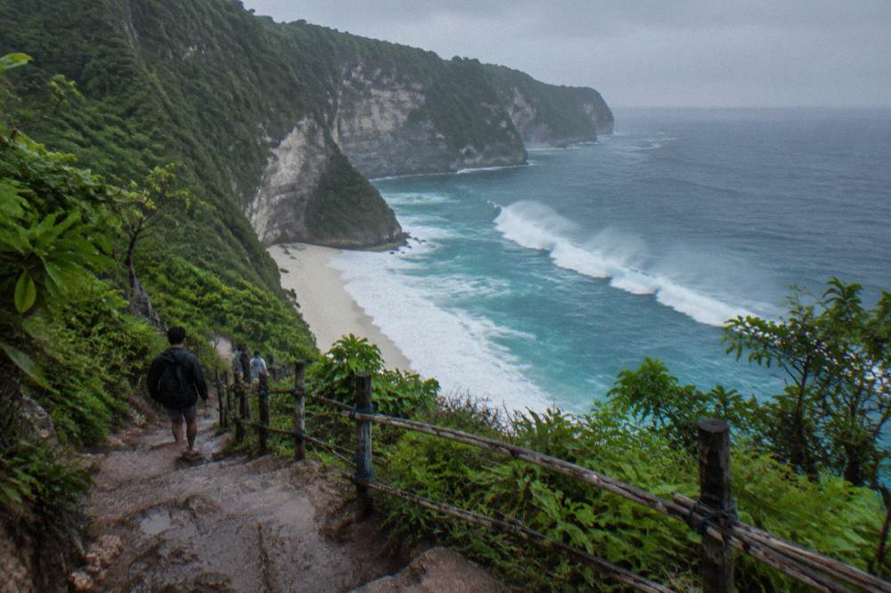 Steep white sand cove with heavy surf breaking along the shoreline