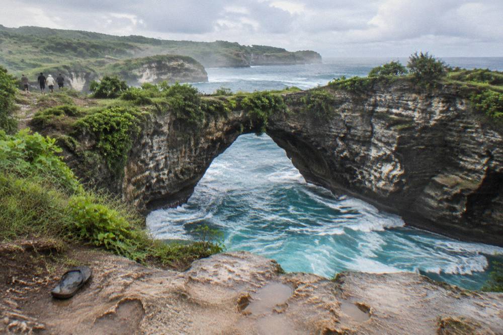 Turquoise water filling a natural rock arch at Broken Beach on Nusa Penida