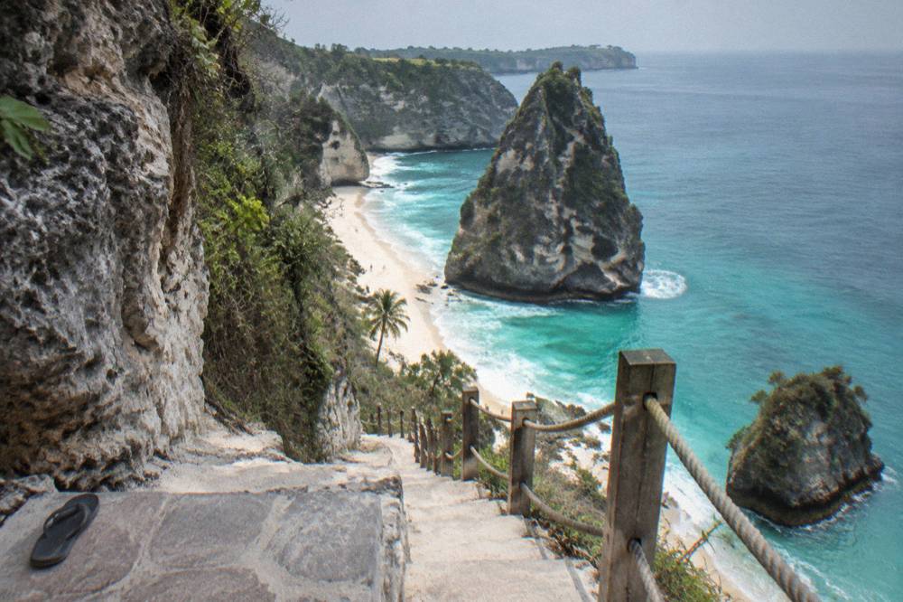 Diamond Beach white sand and turquoise water below steep limestone cliffs