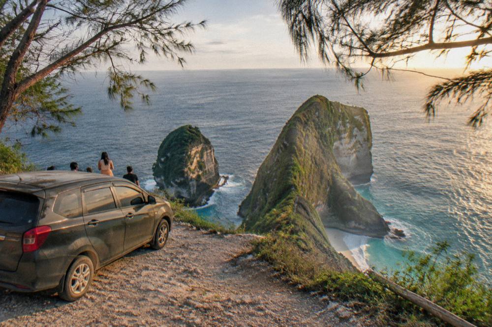 A private car parked at a clifftop viewpoint overlooking the sea
