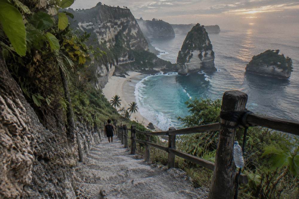 A white sand beach below steep limestone cliffs on the east coast of Nusa Penida
