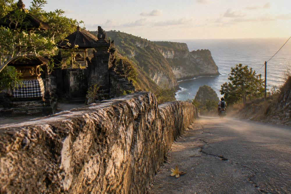 Golden late afternoon light over the sea and cliffs of southwest Nusa Penida